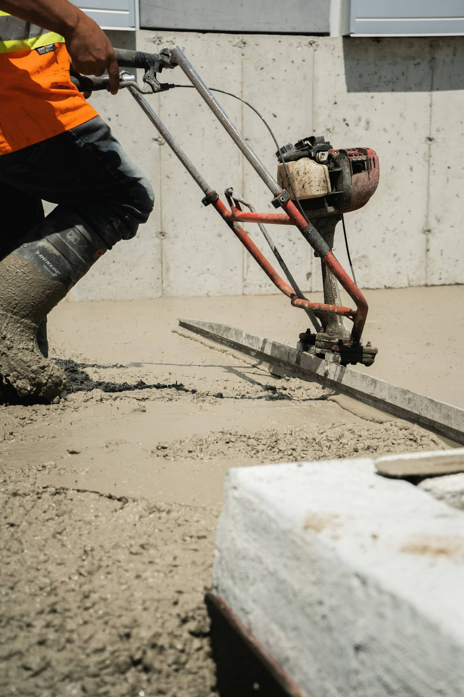 Concrete being placed through a pump line into formwork