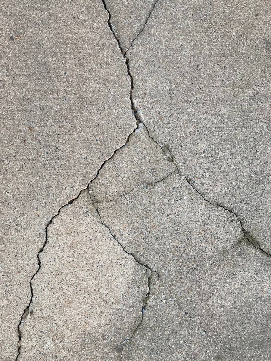 Diamond blade saw cutting a control joint into a concrete slab